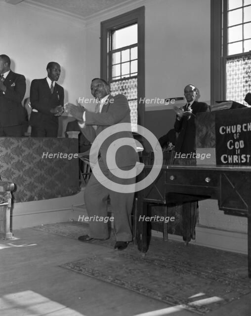 Deacons' corner during Sunday morning service at the Church of God in Christ, Washington, DC, 1942. Creator: Gordon Parks.