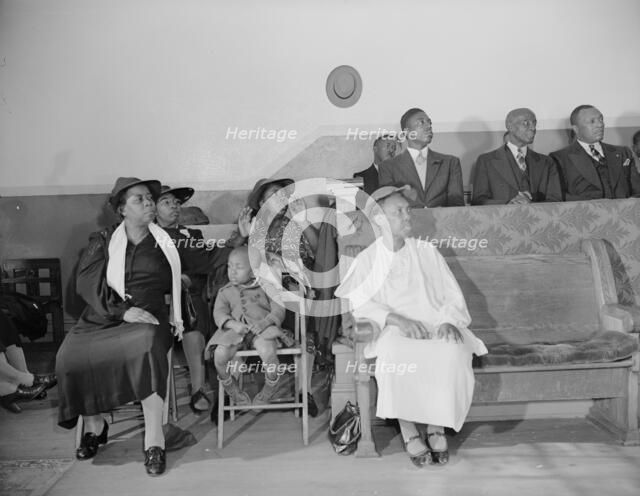 Deacon's corner in the Church of God in Christ, Washington, D.C., 1942. Creator: Gordon Parks.