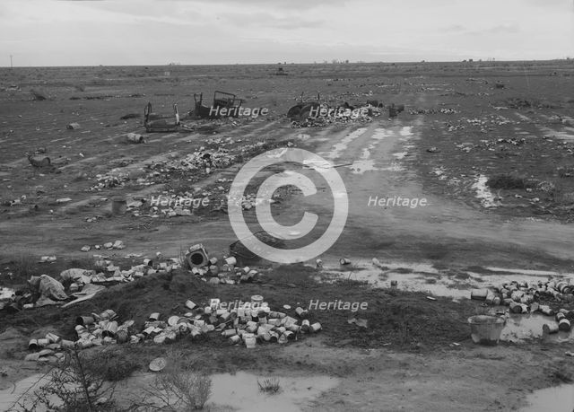 Debris left out on the flats where squatters' camp stood, Kern County, 1939. Creator: Dorothea Lange.