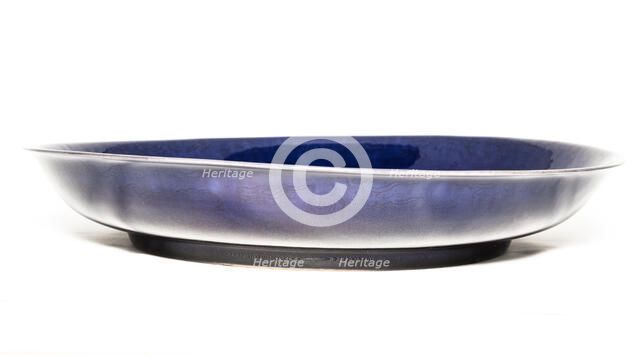 Deep aubergine dish with carved dragons chasing flaming pearl, 1662-1722. Artist: Unknown.