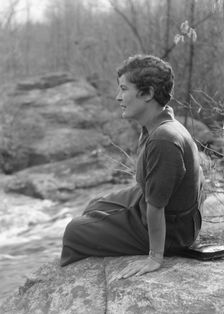DeLamar, Alice, Miss, seated on a rock, between 1927 and 1942. Creator: Arnold Genthe