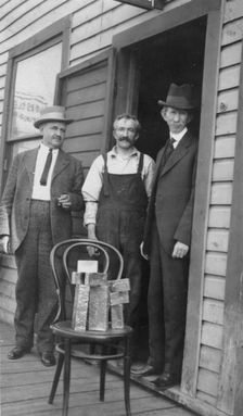 Delegate Wickersham, the assayer and Frank G. Carpenter in front of..., between c1900 and 1916. Creator: Unknown