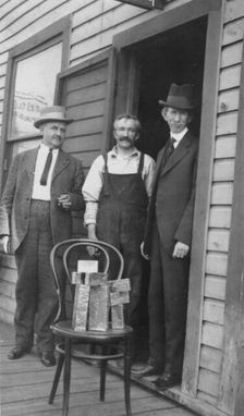 Delegate Wickersham, the assayer and Frank G. Carpenter in front of..., between c1900 and 1916. Creator: Unknown