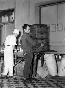 Delivery boy picking up bread boxes at the Lisa Öhman Bakery, Stockholm, Sweden, 10th October 1942. Artist: Karl Sandels