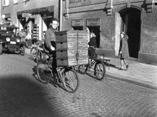 Delivery boy with bread boxes from the Lisa Öhman Bakery, Stockholm, Sweden, 10th October 1942. Creator: Karl Sandels