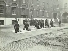 Demonstrating how to pick up an unconscious person, London Fire Brigade Headquarters, London, 1910