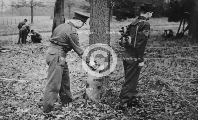 Demonstration of how to place limpet mines, c1943. Creator: British Government.