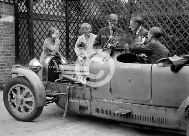 Denis Evans inspecting the plugs of his Bugatti Type 43 2262cc. Artist: Bill Brunell.