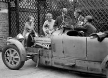 Denis Evans inspecting the plugs of his Bugatti Type 43 2262cc. Artist: Bill Brunell