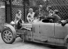 Denis Evans inspecting the plugs of his Bugatti Type 43 2262cc. Artist: Bill Brunell