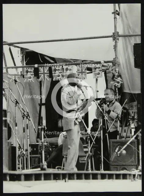 Denis Williams photographing Eddie 'Cleanhead' Vinson at Knebworth, Hertfordshire, 1981. Creator: Unknown.
