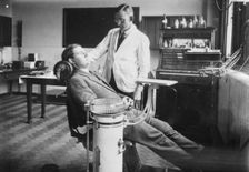 Dentist examines a male patient, Rowntree Factory, York, Yorkshire, 1920
