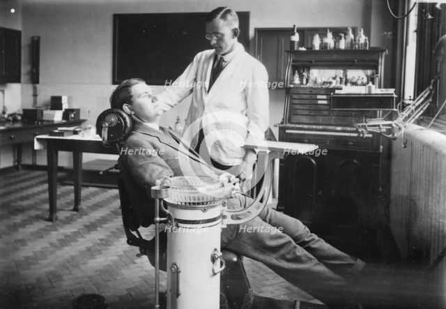 Dentist examines a male patient, Rowntree Factory, York, Yorkshire, 1920. Artist: Unknown