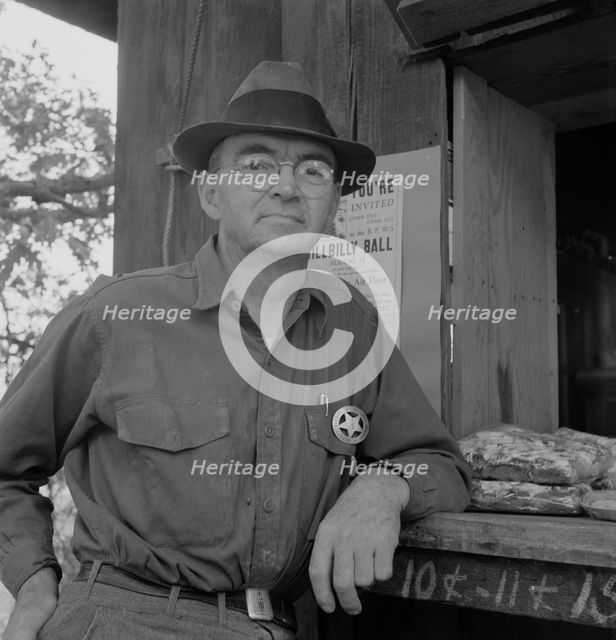 Deputy sheriff, stationed at paymaster's window..., near Grants Pass, Josephine County, Oregon, 1939 Creator: Dorothea Lange.