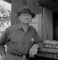 Deputy sheriff, stationed at paymaster's window..., near Grants Pass, Josephine County, Oregon, 1939 Creator: Dorothea Lange