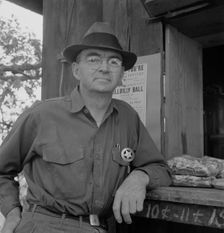 Deputy sheriff, stationed at paymaster's window..., near Grants Pass, Josephine County, Oregon, 1939 Creator: Dorothea Lange