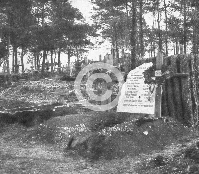 'Derriere L'ennemi refoule; Un cimetiere allemande: au premier plan, deux tombes...1915 (1924).. Creator: Unknown.