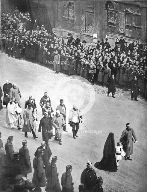 'Derriere le cercueil de Francois-Joseph; le nouveau couple imperial, suivi de souverains..., 1916. Creator: Unknown.