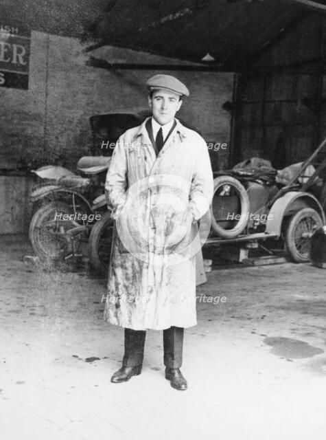 DF Bentley standing in front of a Bentley car, 1921. Artist: Unknown