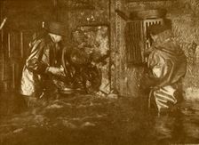 Divers Plugging A Leak During Salvage Operations Waist-Deep In Water On the Lower Decks Of The Germ Creator: Unknown