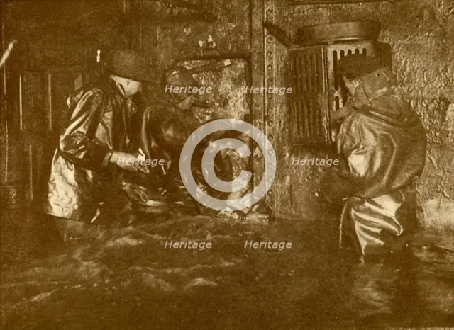'Divers Plugging A Leak During Salvage Operations Waist-Deep In Water On the Lower Decks Of The Germ Creator: Unknown.