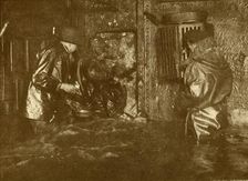 Divers Plugging A Leak During Salvage Operations Waist-Deep In Water On the Lower Decks Of The Germ Creator: Unknown