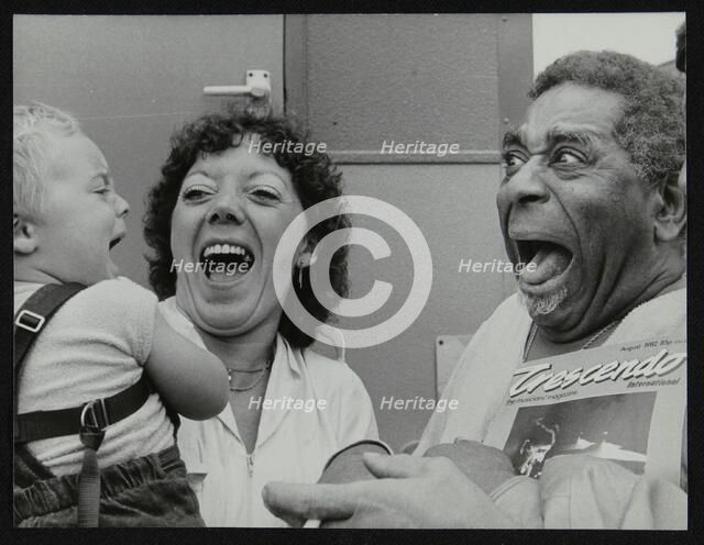 Dizzy Gillespie meeting baby Gary Colfer at Knebworth, Hertfordshire, July 1982. Artist: Denis Williams