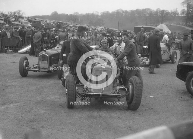 Dick Seaman's ERA, Dick Shuttleworth's Alfa Romeo and a MG Magnette at Donington Park, 1935. Artist: Bill Brunell.
