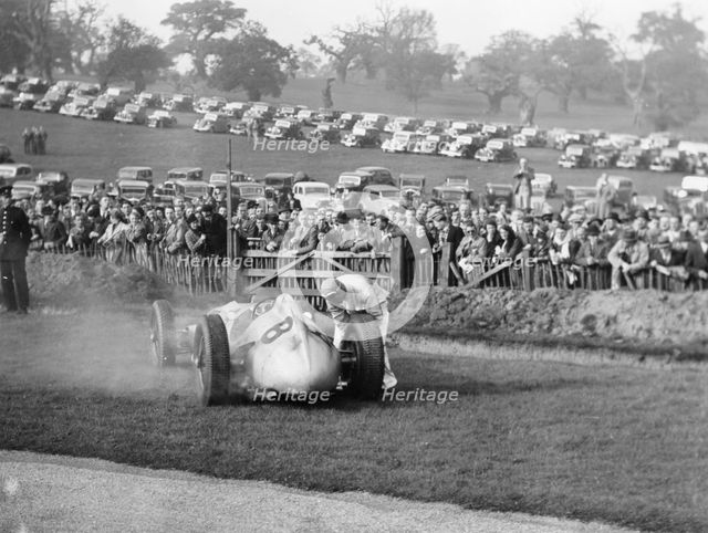 Dick Seaman with his Mercedes, Donington Grand Prix, 1938. Artist: Unknown