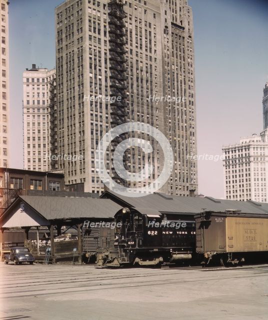 Diesel switch engine moving freight cars at the South water...Illinois Central R.R., Chicago, 1943. Creator: Jack Delano.