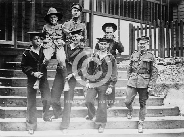 Digby Morton, Phila. Boy Scout, and U.S. Jackies at "Eagle" hut in London, between c1915 and 1918. Creator: Bain News Service.