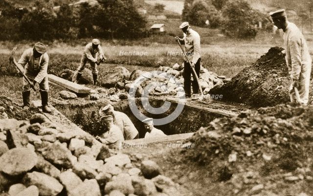 Digging mass graves behind the German lines, World War I, c1914-c1918. Creator: Unknown.