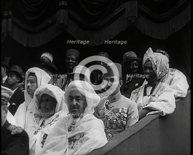 Dignitaries and Representatives from Various African Countries Sitting in Raked Seats at a..., 1939. Creator: British Pathe Ltd.