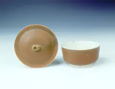Ding persimmon red glazed covered bowl with white glazed interior, Jin dynasty, China, 12th century. Creator: Unknown