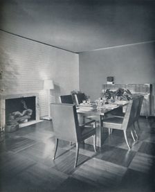 Dining-room furniture with leather-upholstered chairs designed by T. H. Robsjohn-Gibbings and made