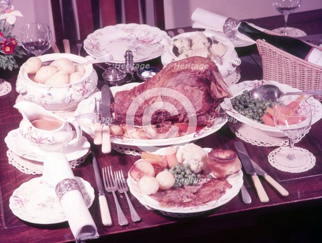 Dining table with roast dinner, c1955. Creator: Arthur Charles Kirby Ware.
