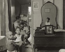 Dinner time at the home of Mrs. Ella Watson, a government charwoman, Washington, D.C., 1942. Creator: Gordon Parks