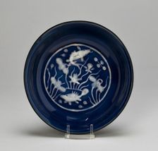 Dish with Fish Swimming in Lotus Pond, Ming dynasty (1368-1644), Wanli reign (1573-1620). Creator: Unknown