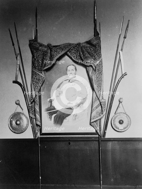 Display with portrait of a man, possibly Chulalongkorn, King of Siam, in Siam exhibit..., 1904. Creator: Frances Benjamin Johnston.