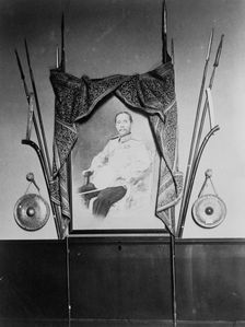 Display with portrait of a man, possibly Chulalongkorn, King of Siam, in Siam exhibit..., 1904. Creator: Frances Benjamin Johnston