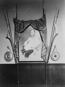 Display with portrait of a man, possibly Chulalongkorn, King of Siam, in Siam exhibit..., 1904. Creator: Frances Benjamin Johnston