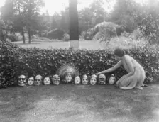 Display of masks made by W.T. Benda, not before 1925 Sept. 20. Creator: Arnold Genthe