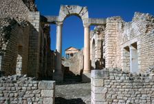 Distant Roman capitol of Dougga seen through an arch, 2nd century