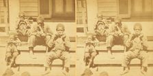 Distinguished southerners, grinding cane. [Children chewing sugar cane on the porch], (1868-1900?). Creator: Unknown