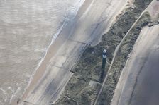 Disused lighthouse and remains of the coastal battery, Spurn Point, East Riding of Yorkshire, 2014.. Creator: Historic England Staff Photographer