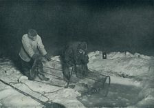 Dr. Atkinson and Clissold Hauling Up The Fish-Trap 28 May 1911, (1913). Artist: Herbert Ponting