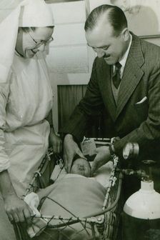 Dr Geoffrey Mutton and Matron Joan Gardner attend to a baby at St Monan's Hospital, c1950. Creator: Unknown