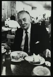 Drummer Max Abrams enjoying a plate of fish and chips in a Soho chip shop, London, 1983. Creator: Denis Williams