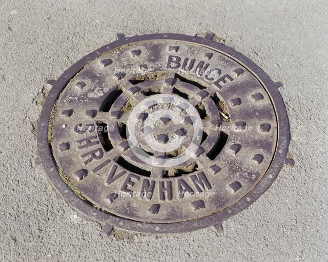 Drain cover plate made by Bunce of Shrivenham, Swindon, Wiltshire, 2006.  Artist: Peter Williams.