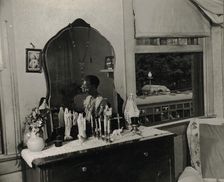 Dresser in the bedroom of Mrs. Ella Watson, a government charwoman, Washington, D.C., 1942. Creator: Gordon Parks